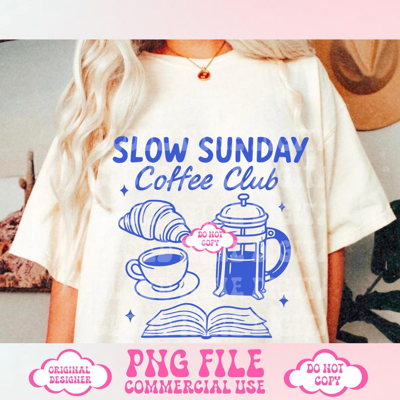 May include: A white t-shirt with a blue graphic design that says "Slow Sunday Coffee Club". The graphic also includes a coffee pot, a cup of coffee, a croissant, and an open book. The text "Do Not Copy" is in a pink cloud on the graphic.
