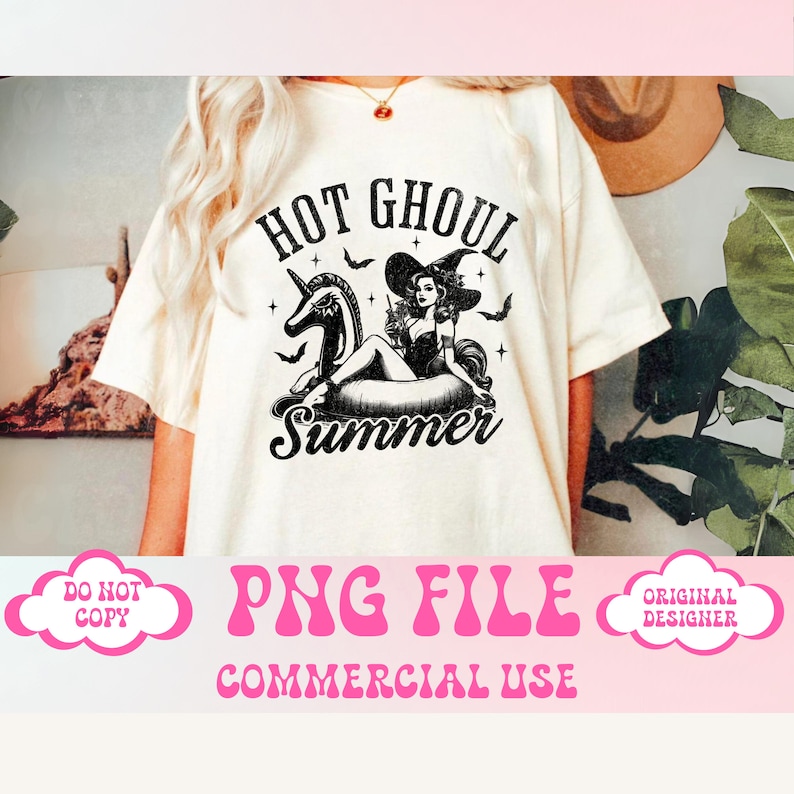 May include: A white t-shirt with a black and white graphic design featuring a witch riding a unicorn float. The text "Hot Ghoul Summer" is printed on the shirt.