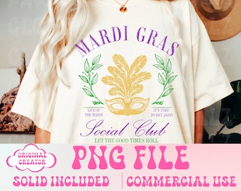 May include: A white t-shirt with a purple and green Mardi Gras design. The design features a mask, feathers, and the text "Mardi Gras Social Club Let the Good Times Roll".