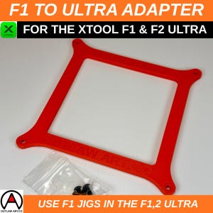 May include: A bright red adapter frame for the Xtool F1 & F2 Ultra laser engravers. The frame has a square shape with rounded corners and mounting holes. The text "F1 TO ULTRA ADAPTER" and "FOR THE XTOOL F1 & F2 ULTRA" are visible.