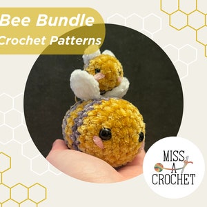 May include: A crochet pattern bundle for making two bee plushies. The larger bee is yellow and purple with black eyes and pink cheeks. The smaller bee is yellow with white wings. The pattern is available as a digital PDF download. ©2024 Miss A Crochet All Rights Reserved
