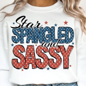 May include: White sweatshirt with a red, white, and blue graphic that says "Star Spangled and Sassy" with stars around the text.