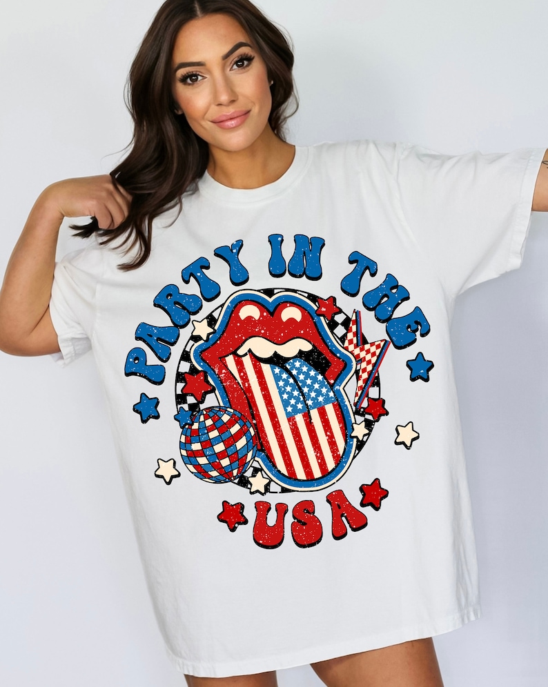 May include: White t-shirt with a graphic of a red, white, and blue tongue with stars and the text "Party in the USA".