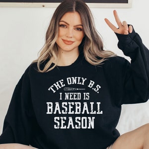 May include: Black sweatshirt with white text that reads "The only B.S. I need is baseball season" with a baseball bat graphic.