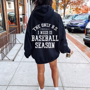 May include: Black hooded sweatshirt with white text that reads "The only B.S. I need is baseball season" with a baseball bat graphic.