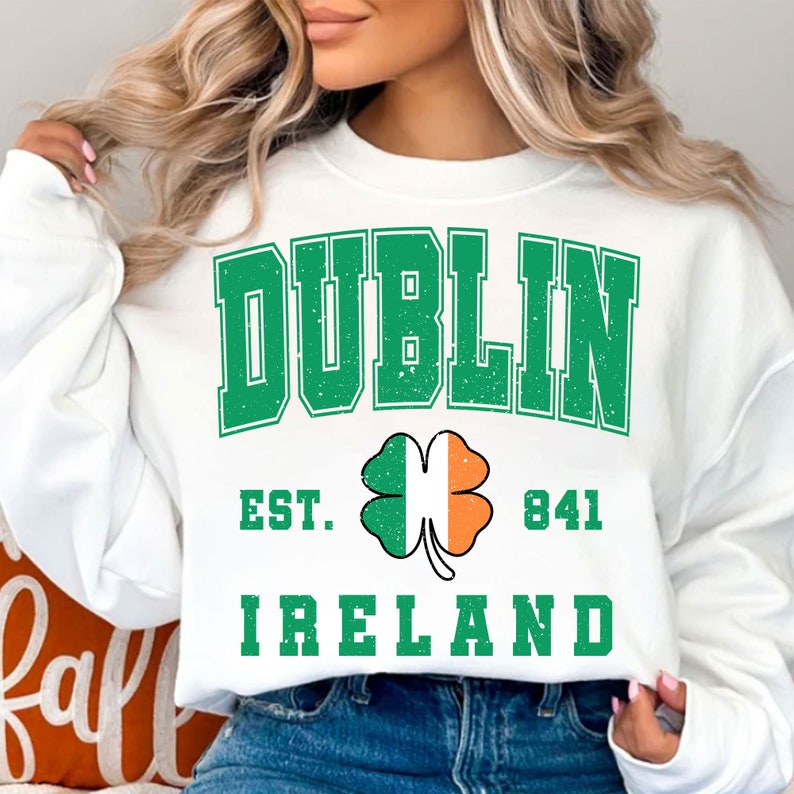 May include: White sweatshirt with a green and white distressed graphic that says "DUBLIN EST. 841 IRELAND" with a green shamrock with an orange and white center.