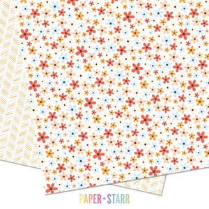 May include: A white background with a repeating pattern of small, colorful flowers. The flowers are in shades of red, orange, yellow, blue, and pink. The background is dotted with small black dots.
