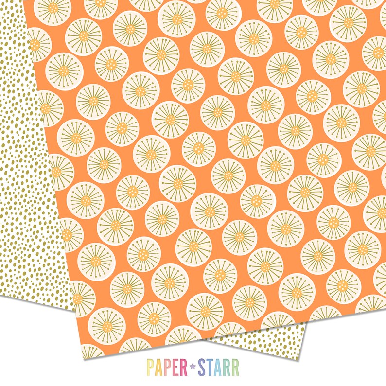 May include: A sheet of orange patterned paper with a white and green floral design. The paper is folded in half and the bottom edge is visible. The text "PAPER + STARR" is printed on the bottom edge of the paper.