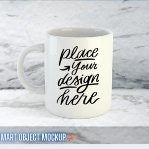 May include: White ceramic mug with a black handwritten design that says "place your design here".