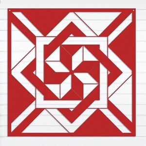 May include: A red and white geometric barn quilt with a swirling design. The quilt is hanging on a white clapboard wall.
