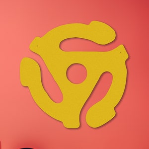 May include: A yellow vinyl record adapter symbol on a red wall, with a record player, a stack of vinyl records, and a speaker on a shelf below.