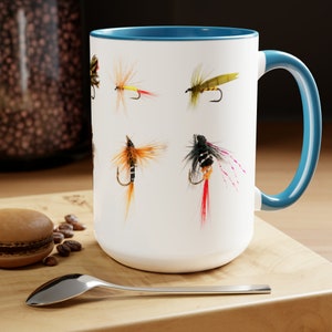 15 oz. fly fishing coffee coffee mug features a variety of fishing flies. Coffee and fly tying are a great combo. Good fishing dad gift.