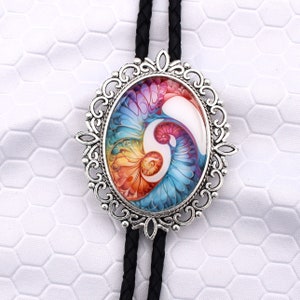 May include: Oval bolo tie with a silver-colored filigree frame. The pendant features a colorful, abstract design with swirls of blue, orange, pink, and white. The tie has a black braided cord.