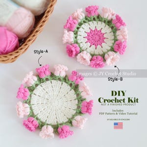 May include: Two handmade crochet flower coasters in pink, white, and green. The coasters are circular with a floral design and are labeled Style-A and Style-B. The image also includes a DIY Crochet Kit with a PDF pattern and video tutorial.