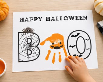 May include: A white sheet of paper with the text HAPPY HALLOWEEN at the top. Below, the word BOO is written with a spider web letter B, an orange handprint shaped like a pumpkin in the middle, and a letter O decorated with black bats.