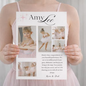 May include: A white card with the name "Amy Lee" and ballet-themed photos. The card includes a message from "Mom & Dad" congratulating Amy on her performance. The card is held by a person wearing a pink dress.