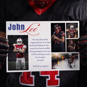 May include: A person holding a white card with the name "John Lee" in blue and red script. The card includes images of football players and a message of congratulations and support.