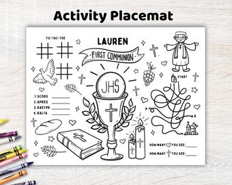 May include: A black and white activity placemat for a First Communion featuring the name Lauren, a chalice with a host, a Bible, a dove, candles, a maze, and tic-tac-toe games. The design includes religious symbols like crosses, grapes, and wheat.