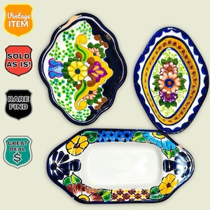 May include: A collection of four colorful, hand-painted ceramic serving dishes. The dishes feature floral designs in shades of yellow, blue, green, and purple. The shapes include a rectangular tray and three decorative plates. The image includes the text "Vintage Item", "Sold As Is!", "Rare Find", and "Great Deal".