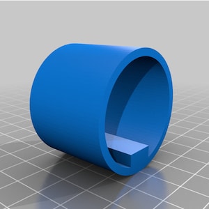 May include: A blue plastic ring with a rectangular opening. The ring is designed to hold a small object, such as a key or a piece of jewelry.