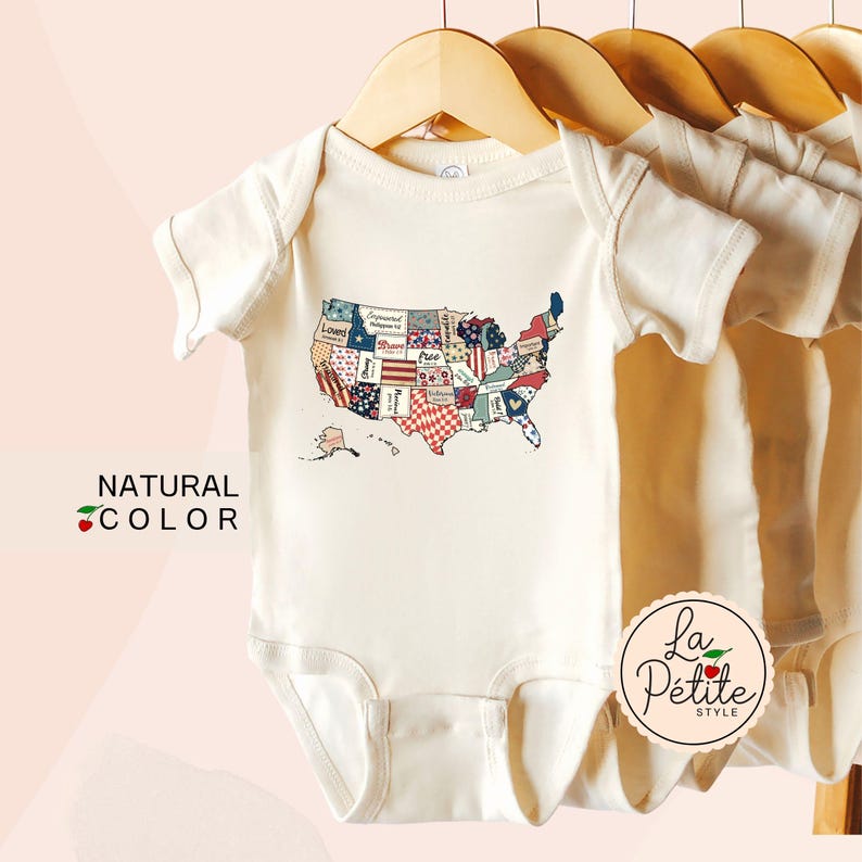 May include: A white baby onesie with a patchwork map of the United States in red, white, and blue. The onesie has the text "La Petite Style" on the bottom right corner.