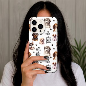 May include: White phone case featuring a collage of various dog breeds, paw prints, and the text "Life's better with dogs." The case showcases a variety of puppies, including a husky, beagle, and dachshund.