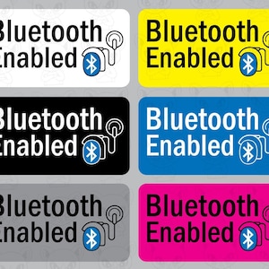 May include: Six different colored square stickers with the text "Bluetooth Enabled" and a Bluetooth symbol with a headset icon. The stickers are white, yellow, black, blue, gray, and pink.