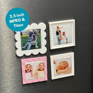May include: Four square photo magnets, each 6.35 cm. One white scalloped frame with a dog photo, one white beaded frame with a family photo, one pink frame with two girls, and one white frame with a baby.