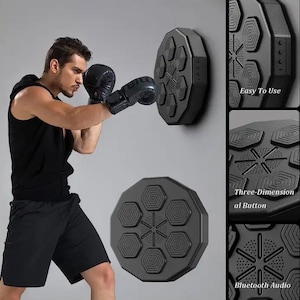 May include: Black boxing training target with hexagonal pads, mounted on a wall. A person wearing black boxing gloves is punching the target. Additional details show "Easy to Use", "Three-Dimensional Button", and "Bluetooth Audio".