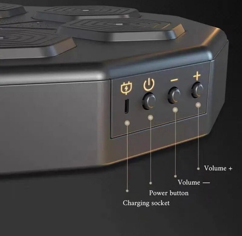 May include: A black wireless charging station with a hexagonal design. It has a charging socket, power button, and volume controls. The top has four circular charging pads. Text labels the charging socket, power button, and volume controls.