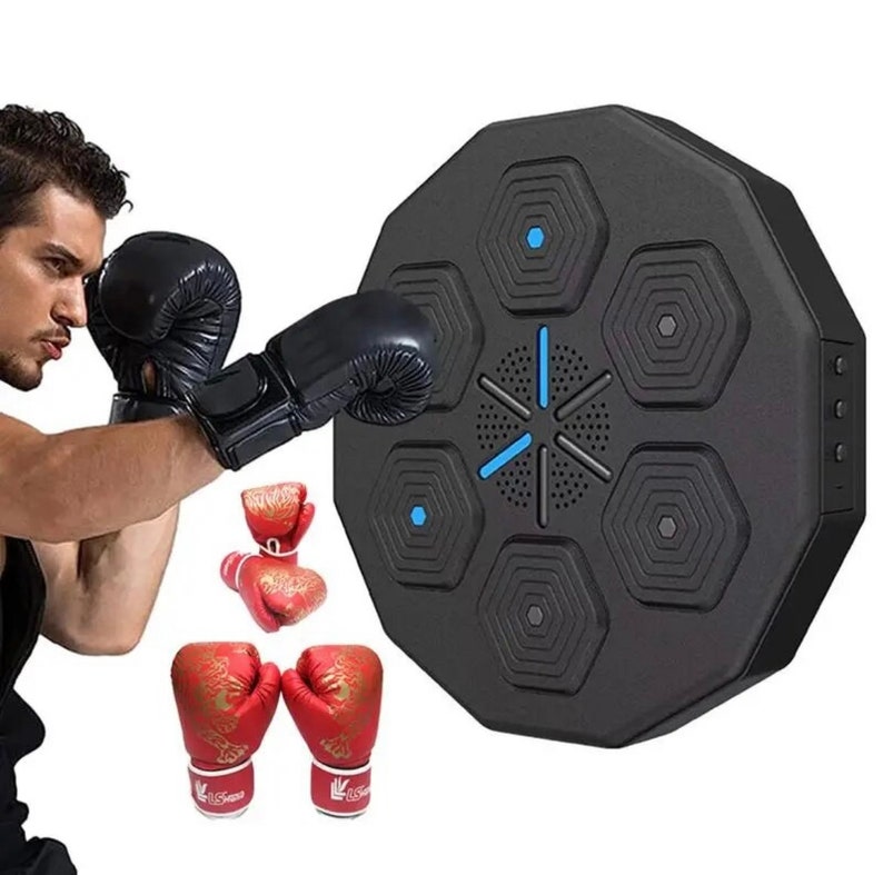 May include: A black, octagonal boxing training target with blue detailing. The target features six hexagonal pads and a central speaker. A person wearing black boxing gloves is shown practicing punches. Red boxing gloves with gold designs are also visible.