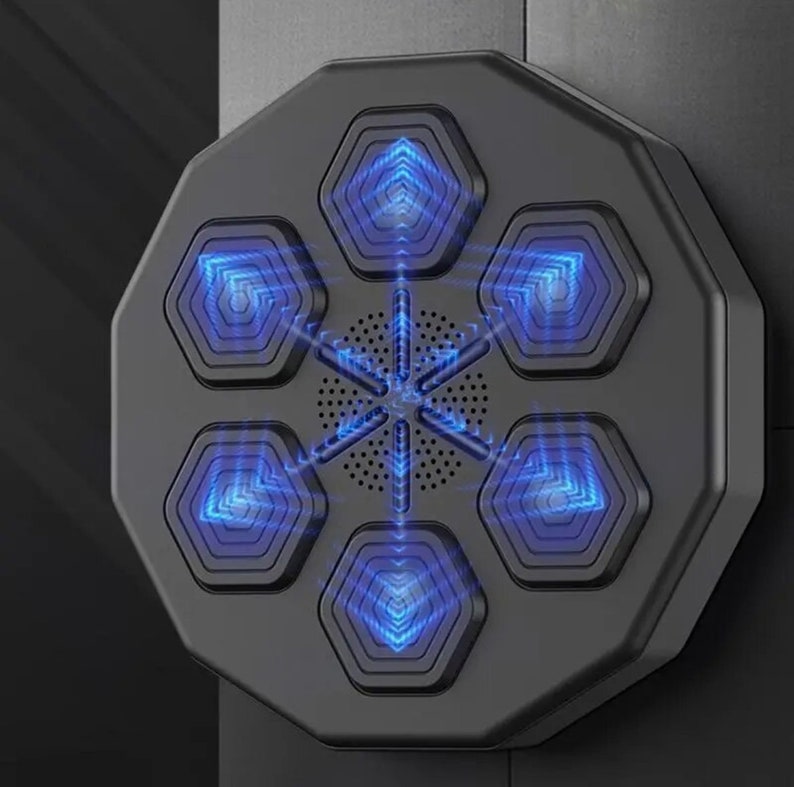 May include: A black, octagonal device featuring six hexagonal blue-glowing panels around a central speaker. The panels have a geometric design, and the device is mounted on a dark surface. The overall design is modern and technological.