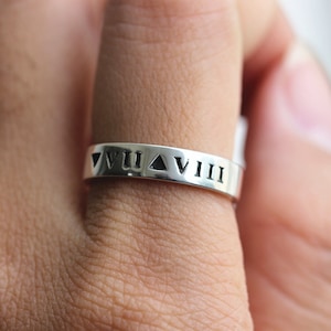 以下が含まれることがあります： バンドにローマ数字のVII、三角形、VIIIが刻まれた銀のリングです。