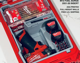May include: A red Milwaukee Packout organizer containing a custom grey insert for an M12 Fuel Surge 2551-20 tool. The organizer holds a drill bit case, two batteries, a driver bit, and various small bits. Text reads: CUSTOM PACKOUT ORGANIZER M12 FUEL SURGE 2551-20 INSERT ASA PRINTED FULL-HEIGHT WALLS.