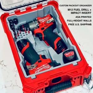 May include: Red and black Milwaukee M12 Fuel drill and impact insert set in a custom Packout organizer. The organizer is red with gray inserts and a clear lid. The text on the side says "CUSTOM PACKOUT ORGANIZER M12 FUEL DRILL + IMPACT INSERT ASA PRINTED FULL-HEIGHT WALLS".