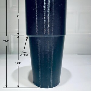 May include: A dark navy blue cylindrical object with a 3-inch top section and a 4 7/8-inch bottom section. The total height is 7 7/8 inches. The text "2mm OFFSET" is visible. The object is likely a tumbler or cup.