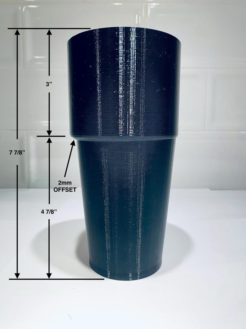 May include: A dark navy blue cylindrical object with a 3-inch top section and a 4 7/8-inch bottom section. The total height is 7 7/8 inches. The text "2mm OFFSET" is visible. The object is likely a tumbler or cup.
