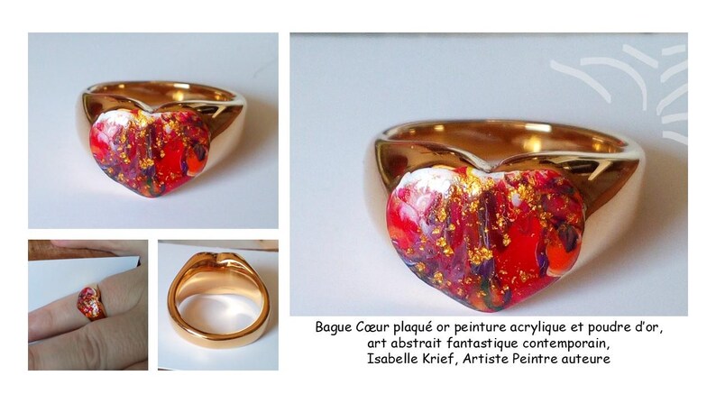 May include: Gold-plated ring with a heart-shaped centerpiece. The heart features a vibrant abstract design in red, gold, and purple hues. The ring's band is a polished gold color. The image includes the text: Bague C&oelig;ur plaqu&eacute; or peinture acrylique et poudre d'or, art abstrait fantastique contemporain, Isabelle Krief, Artiste Peintre auteure.