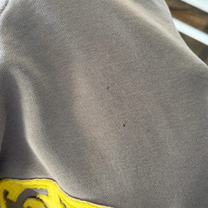 May include: A white ceramic mug with a black handle and the text "But First, Coffee" in a handwritten style. The mug is on a white surface. The mug is approximately 4 inches tall.