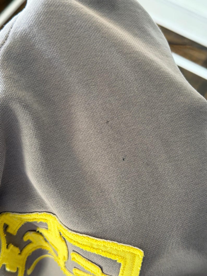 May include: A white ceramic mug with a black handle and the text "But First, Coffee" in a handwritten style. The mug is on a white surface. The mug is approximately 4 inches tall.