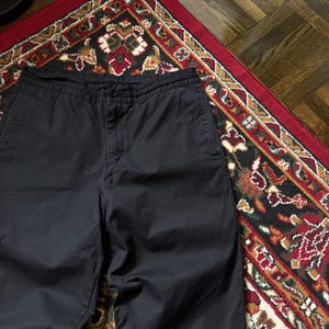 May include: A distressed wooden sign with the words "Welcome to our home" in white lettering. The sign has a rustic finish, ideal for a front porch or hallway, creating a welcoming atmosphere.