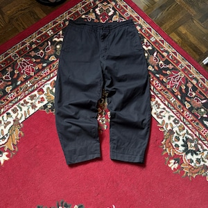 May include: A white ceramic mug with a black handle and the text "But First, Coffee" in a handwritten style. The mug is on a white surface. The mug is approximately 10 cm tall.