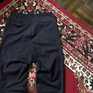 May include: A trio of ceramic mugs with a speckled, matte finish in cream, light grey, and dark grey. Each mug features a simple, modern design and a rounded handle. Ideal for tea or coffee.