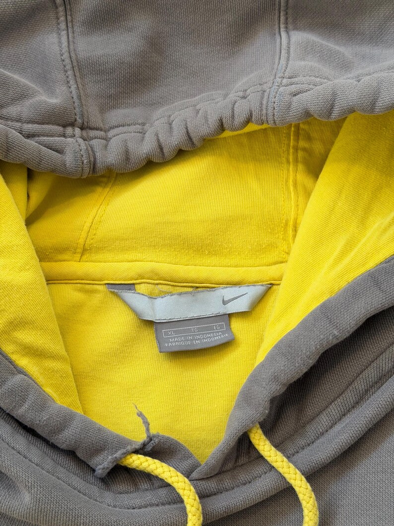 May include: A white ceramic mug with a black handle and the text "But First, Coffee" in a bold, black font. The mug sits on a white surface, showcasing its clean design.