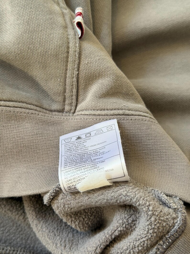 May include: A white ceramic mug with a black handle and the text "But First, Coffee" in a black, bold font. The mug is sitting on a white surface. The mug appears to be 4 inches tall.