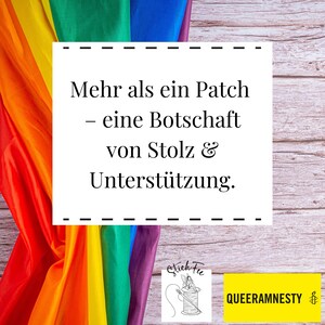 May include: A rainbow flag draped over a wooden surface with a white rectangle containing the text "Mehr als ein Patch - eine Botschaft von Stolz & Unterst&uuml;tzung."  Below the rectangle is a black and white illustration of a sewing needle and thread with the text "Stich Fu" and a yellow rectangle with the text "QUEERAMNESTY".