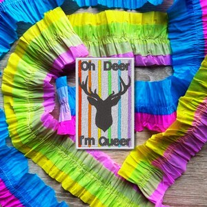 May include: A rainbow-coloured patch with a deer silhouette and the text "Oh Deer I'm Queer".