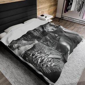 May include: A white duvet cover with a black and white photo collage of cityscapes and an airship. The photos include a view of a city from above, a close-up of a building, and a view of an airship flying over a city.
