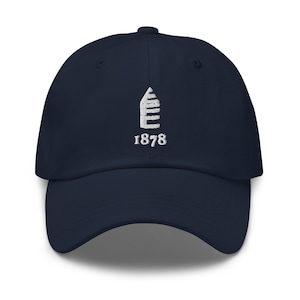 May include: A navy blue baseball cap with a white embroidered logo of a building and the year 1878.