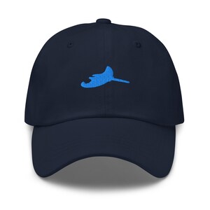 May include: A navy blue baseball cap with a blue embroidered stingray design.